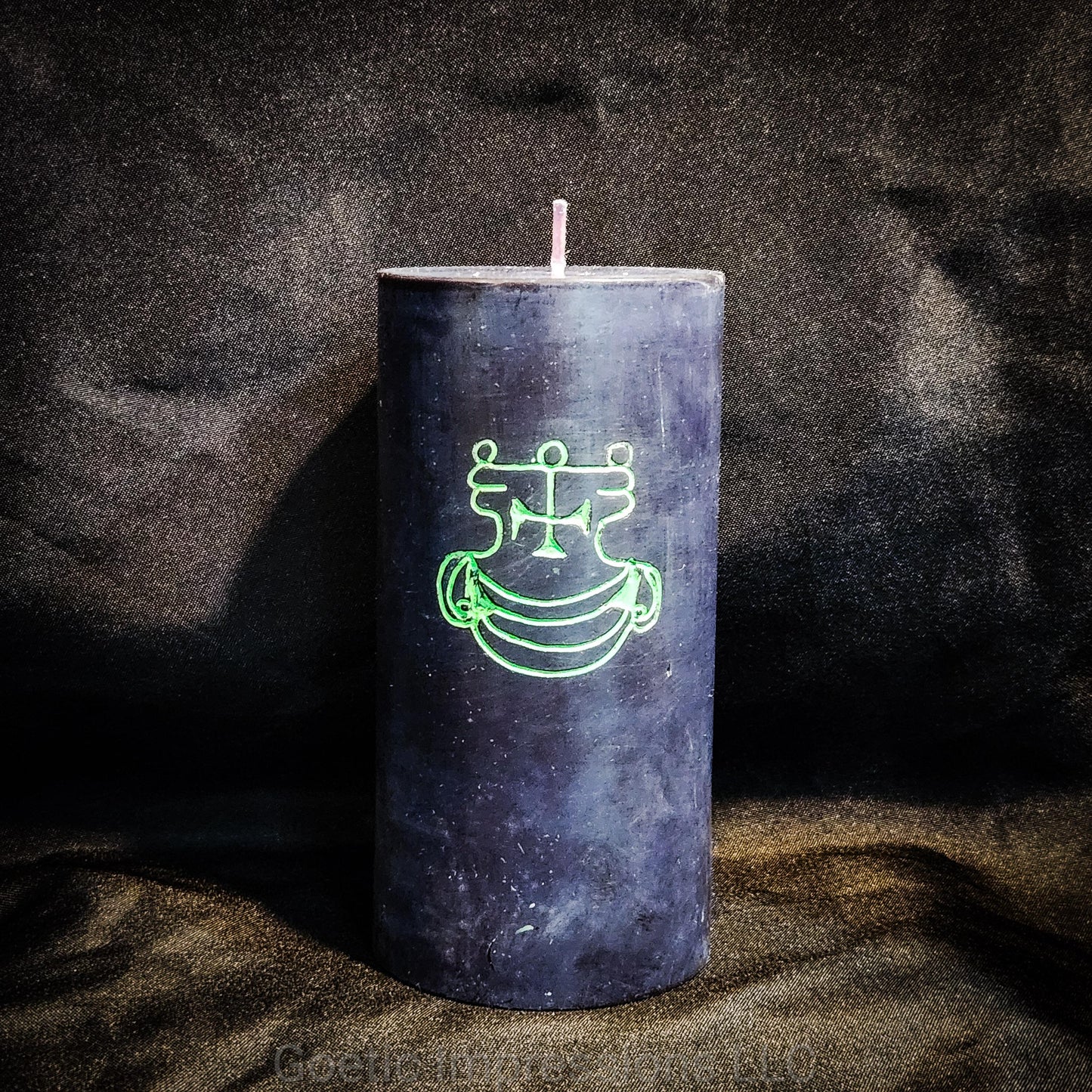 A black 3"x6" pillar candle with a hand carved green sigil of Agares from the Lesser Key of Solomon.