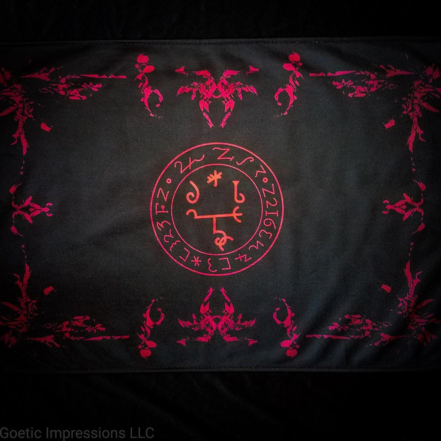 A red and black altar cloth with the sigil of Beelzebub in the center.