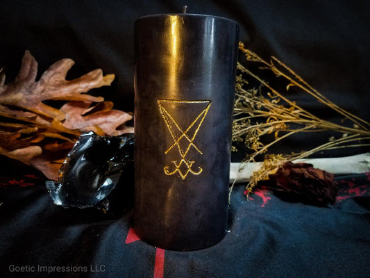 Black pillar candle with a gold Lucifier sigil carved into it.