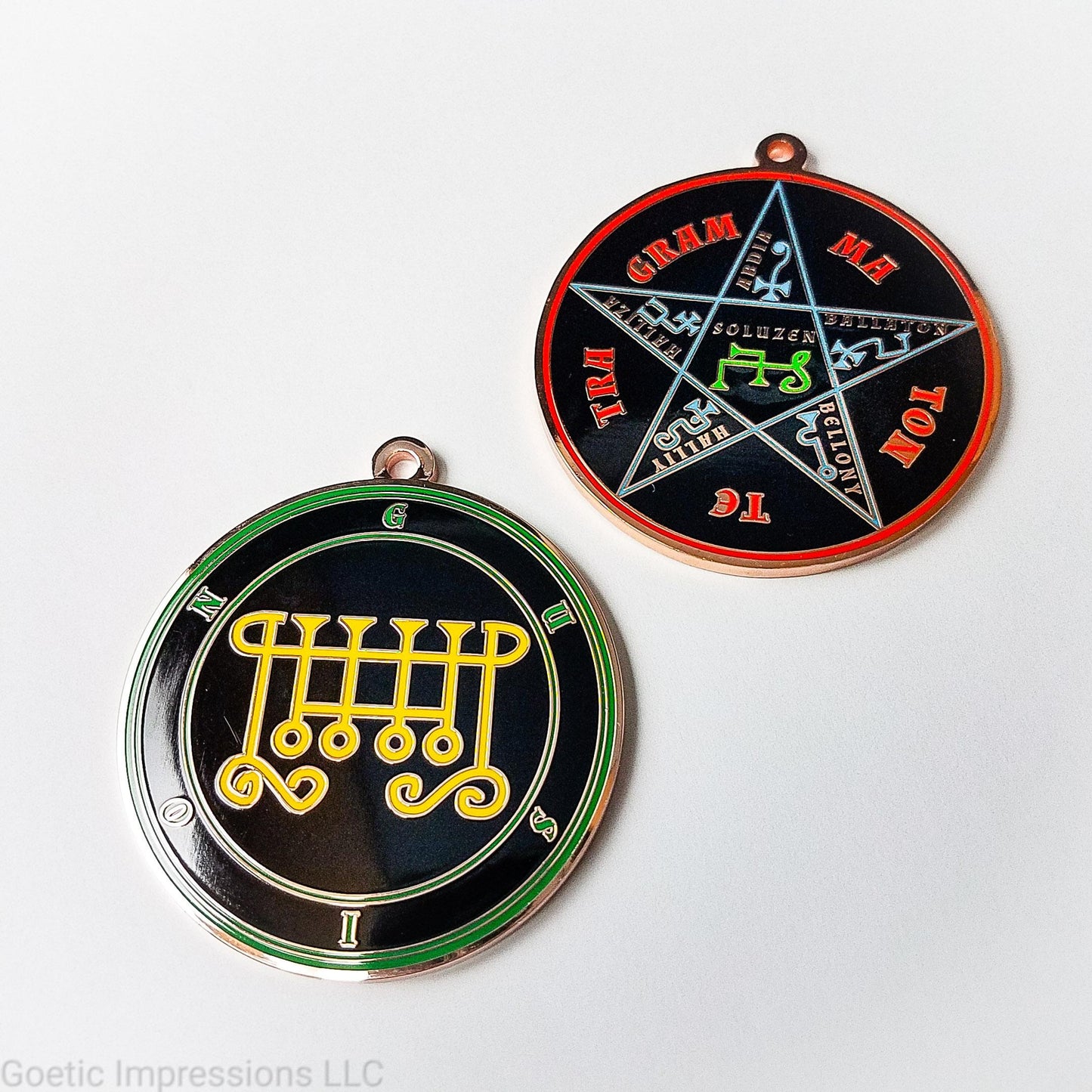 Two copper plated medallions featuring the front and back of the Ars Goetia spirit Gusion. The sigil is yellow with the name and circle surrounding in green. The Reverse is the TETRAGRAMMATON. The pentacle is blue with a red circle. Tetragrammaton is in red. The center sigil is green.