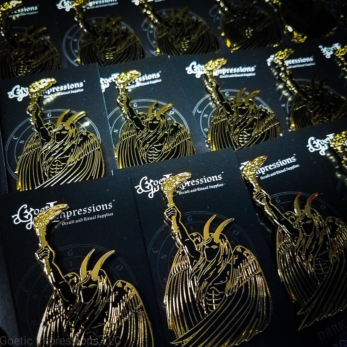 A series of Lucifer pins on card backs ready to be shipped.