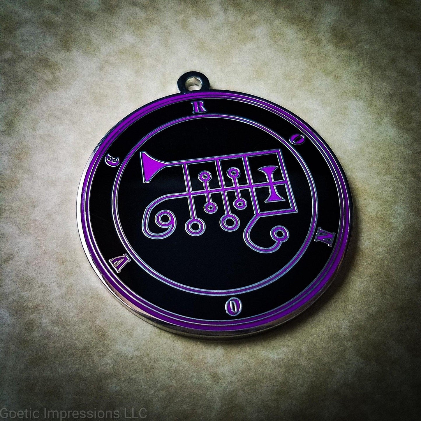 Talisman of goetic spirit Ronove. Ronove's sigil is purple with the circles surrounding in purple along with the name on a black background.