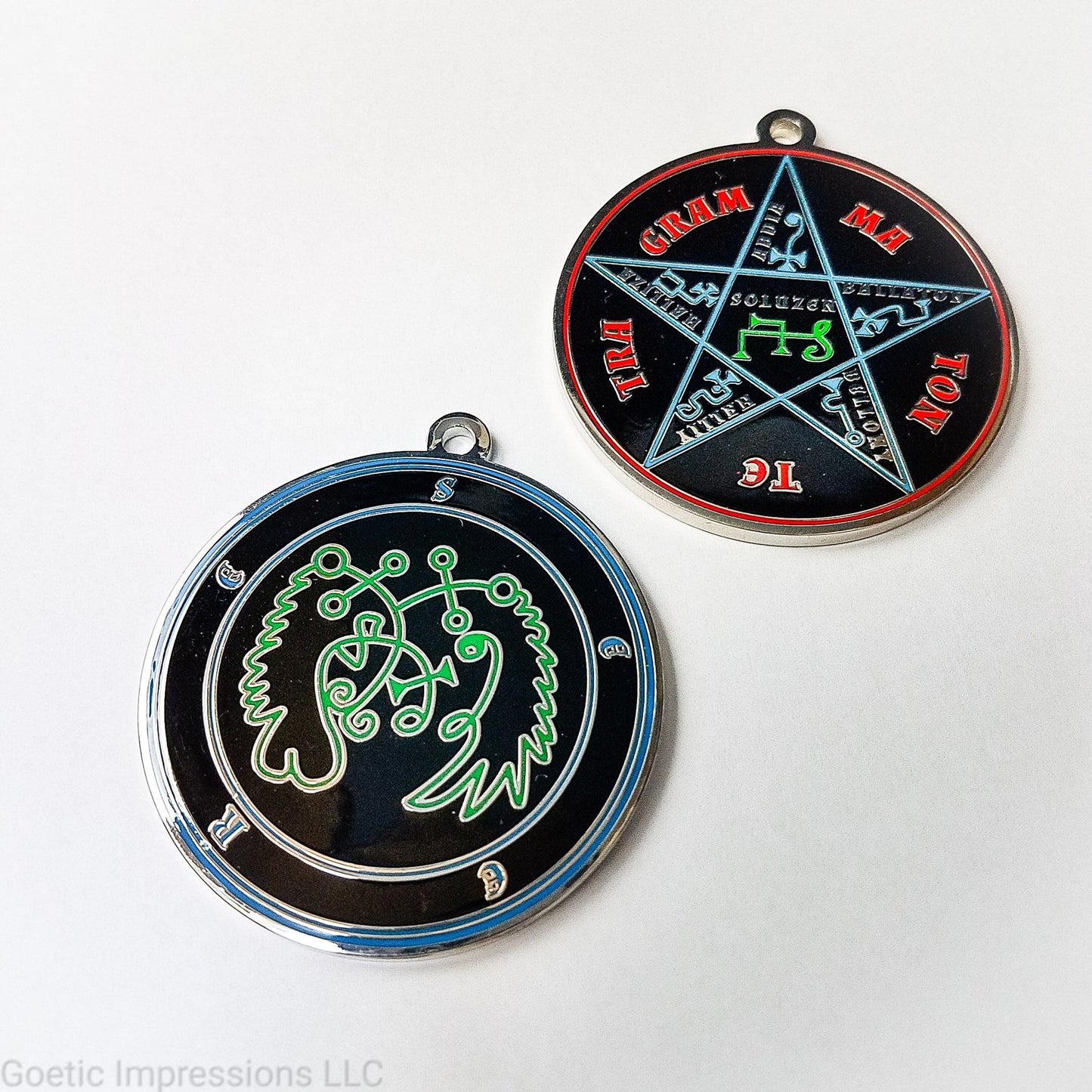 Two medallions featuring the front and back of the Ars Goetia spirit Seere. The sigil is green with the name and circle surrounding in blue. The Reverse is the TETRAGRAMMATON. The pentacle is blue with a red circle. Tetragrammaton is in red. The center sigil is green. The seal is plated in silver.