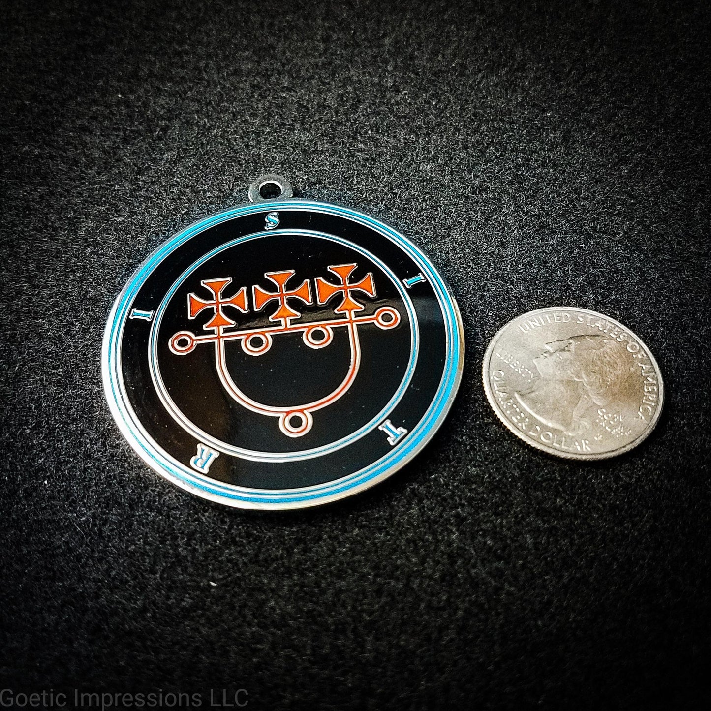 Talisman of Sitri next to a quarter to show size. The medallion is 2 inches in diamter. The sigil for Sitri is in red with surrounded text and circles in blue.