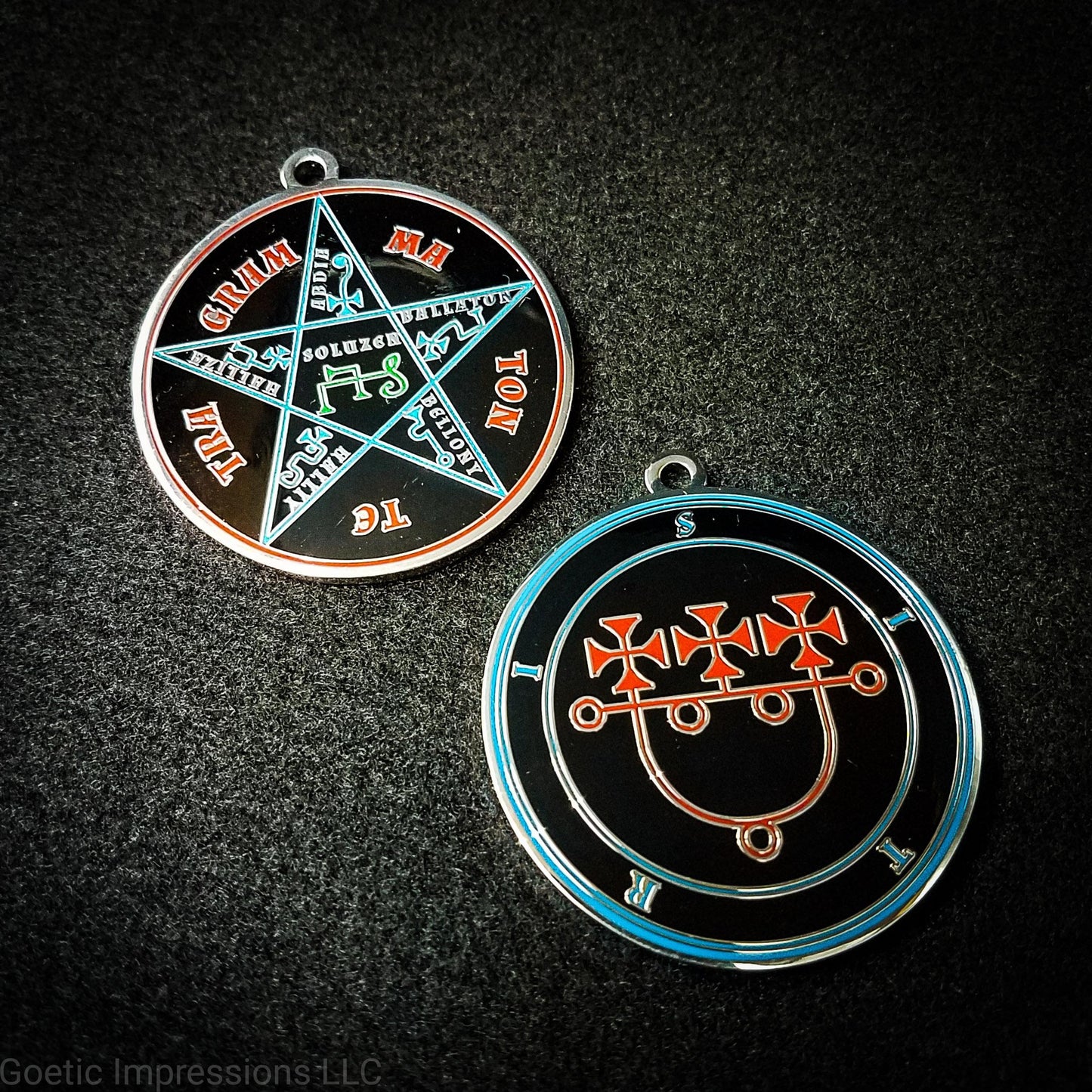 Two medallions showing the front and reverse side of the Goetic Spirit Sitri. The circles and text for Sitri is colored in blue with the sigil in red on a black background. The reverse side is the Pentacle of Solomon with TETRAGRAMMATON text in red, the star and sigils in blue and the center sigil in green. The seal is silver plated.