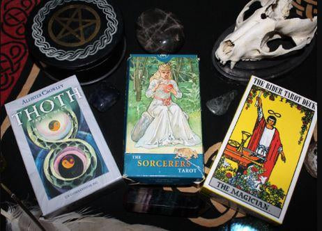 Tarot card decks for Thoth, Sorcerers and Rider Waite tarot cards on an altar.