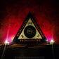 The Magickal Triangle of Solomon with a Bune pentacle in the center. On either side of the Triangle are lit candles.