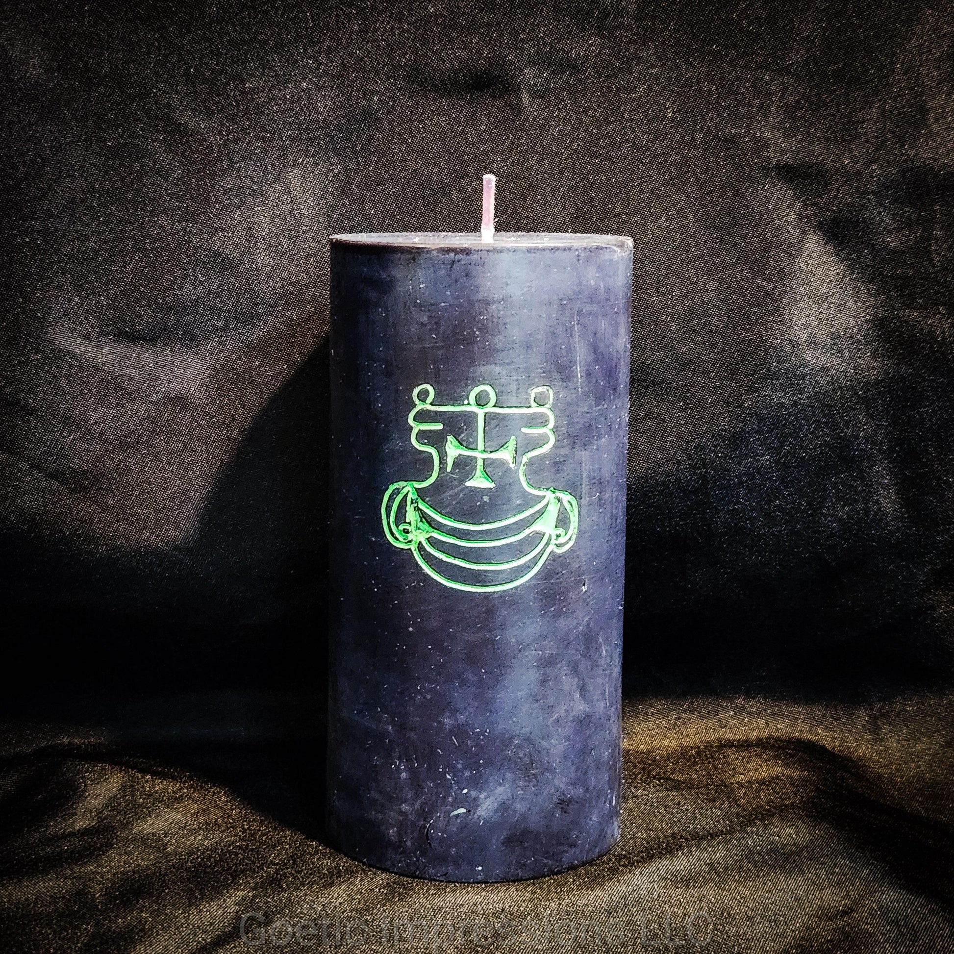 A black 3"x6" pillar candle with a hand carved green sigil of Agares from the Lesser Key of Solomon.