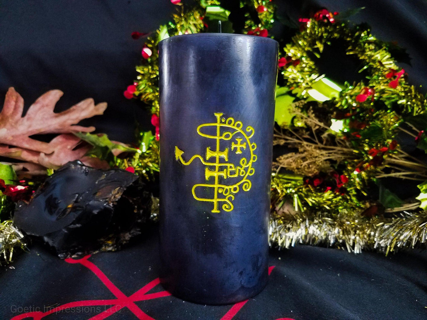 Black pillar candle with yellow Asmoday sigil carved in it