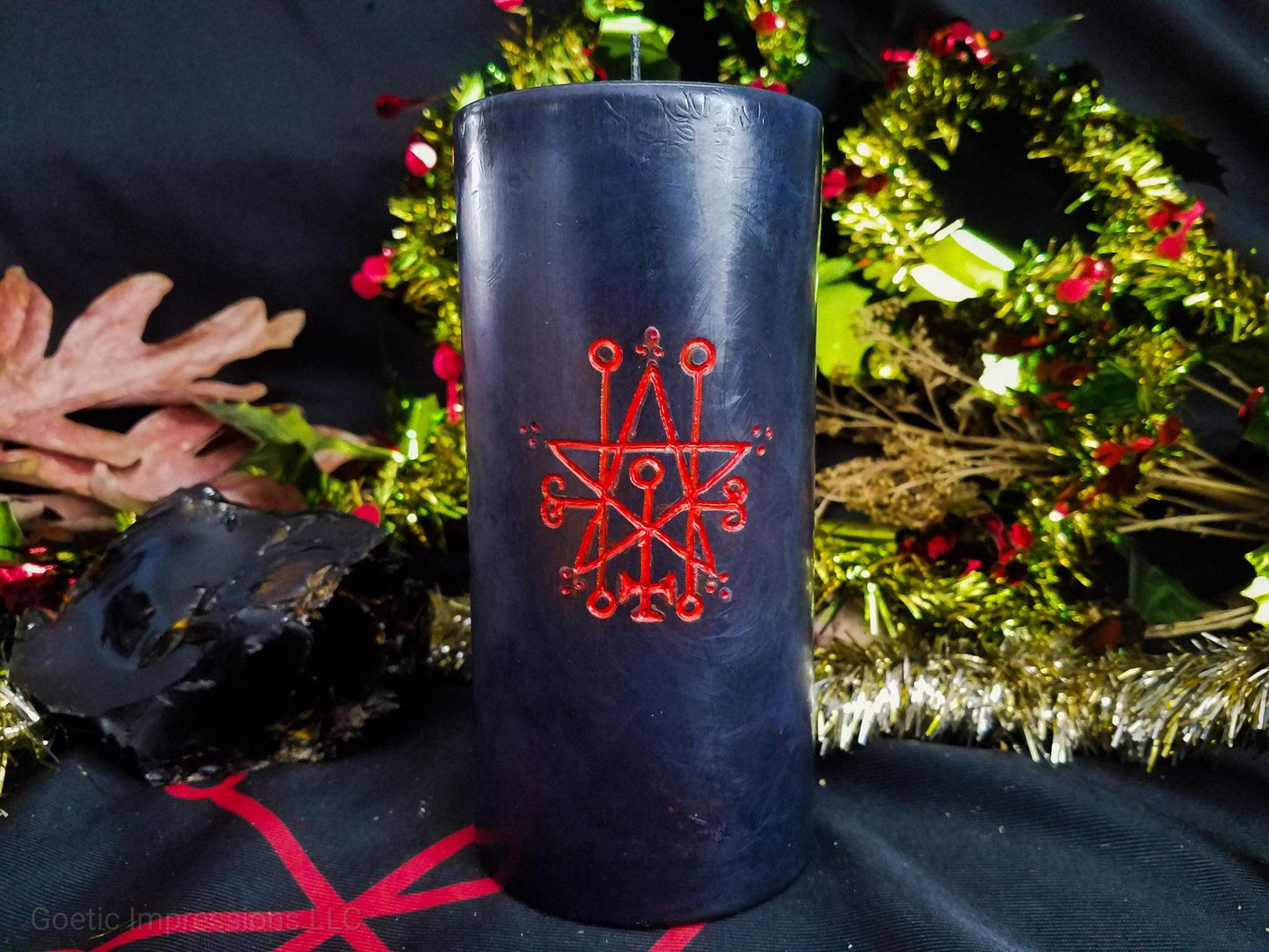 Black pillar candle with Red Astaroth sigil carved into it