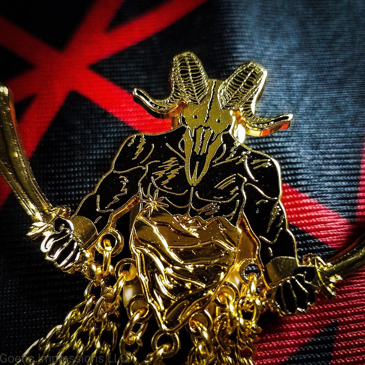 A close up of a black and gold enamel pin of the demon Azazel. Azazel has a ram skull of a head and a human body with scars. He is holding a scimitar in each hand.