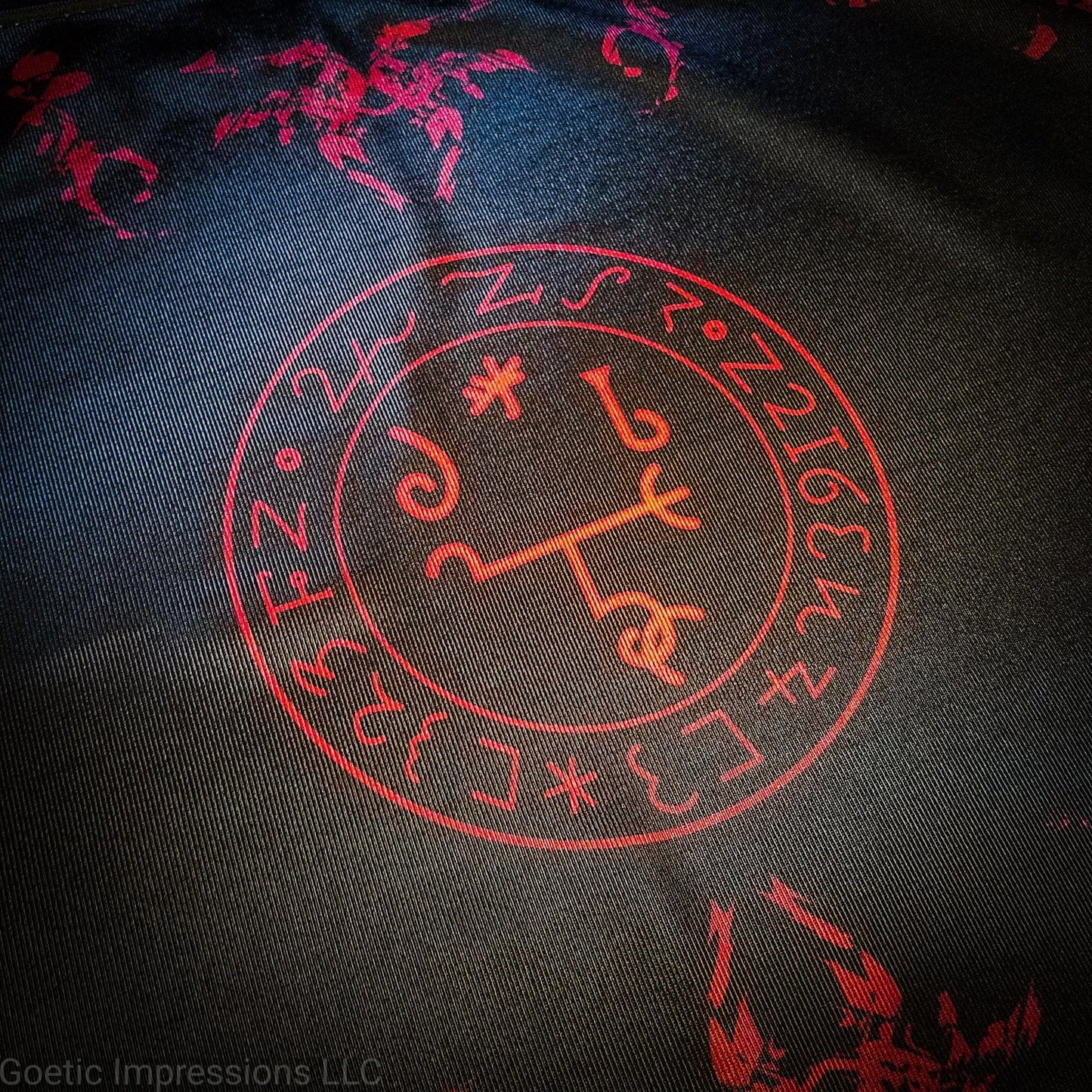 A red and black altar cloth with the sigil of Beelzebub in the center. 