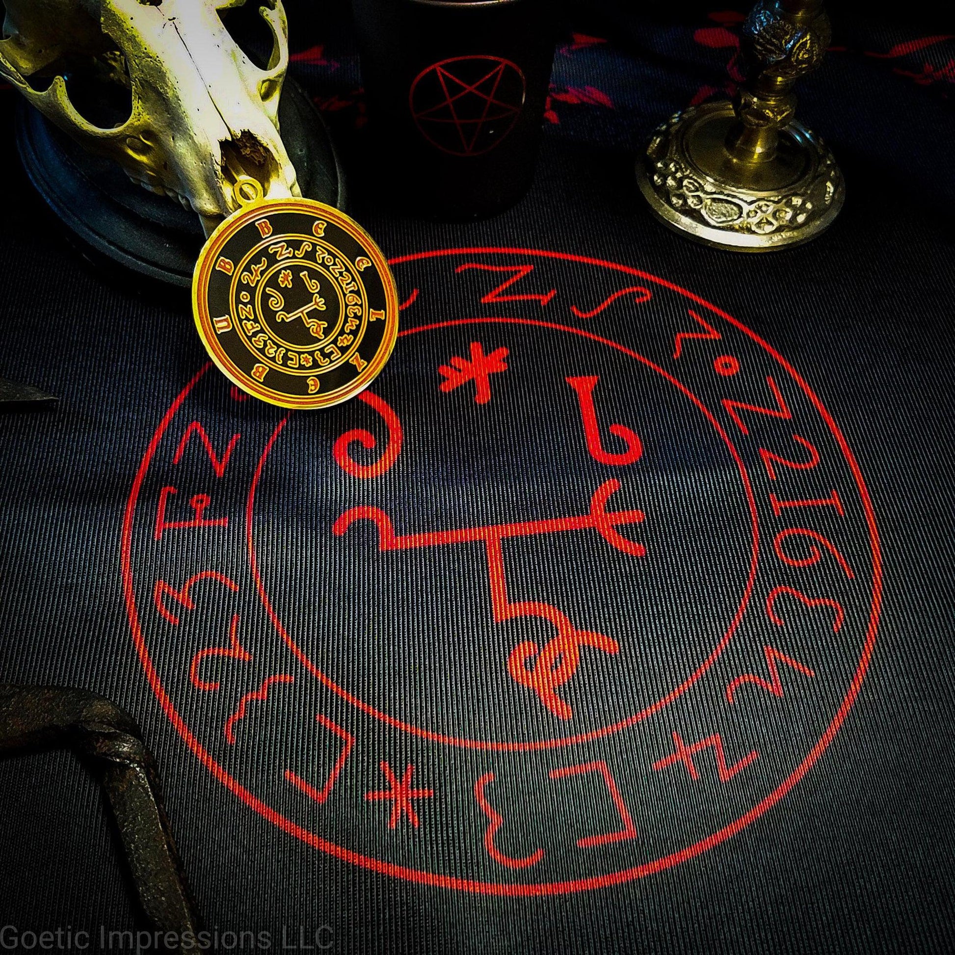 A red and black altar cloth with the sigil of Beelzebub in the center. 
