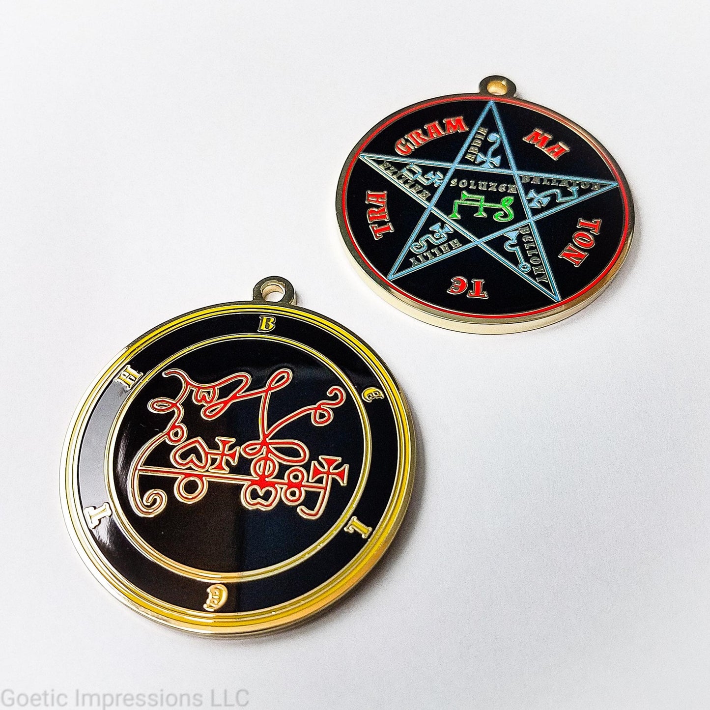 Two medallions featuring the front and back of the Ars Goetia spirit Beleth. The sigil is red with the name and circle surrounding in yellow. The Reverse is the TETRAGRAMMATON. The pentacle is blue with a red circle. Tetragrammaton is in red. The center sigil is green. The seal is plated in gold.