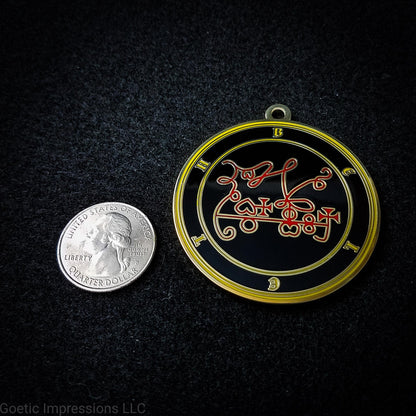Seal of Beleth next to a quarter. The seal medallion measures two inches in diameter. The sigil is red with yellow letters and circles on a black background. 