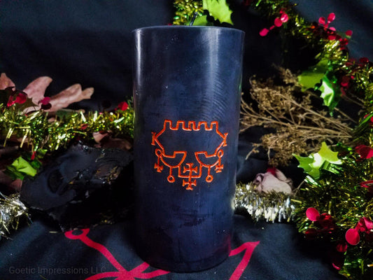 Black pillar candle with orange Belial sigil carved into it