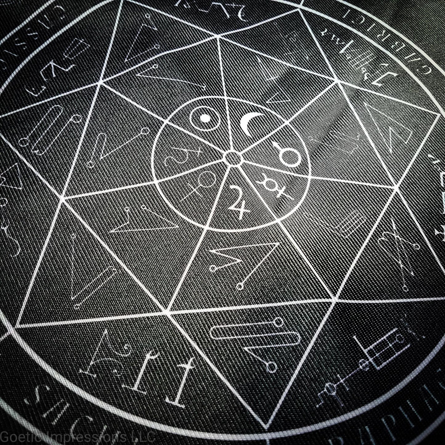 A black and white altar cloth with a seal of the planetary Archangels in the center. The seal contains various astrological sigils.