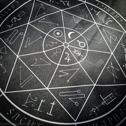 A black and white altar cloth with a seal of the planetary Archangels in the center. The seal contains various astrological sigils.