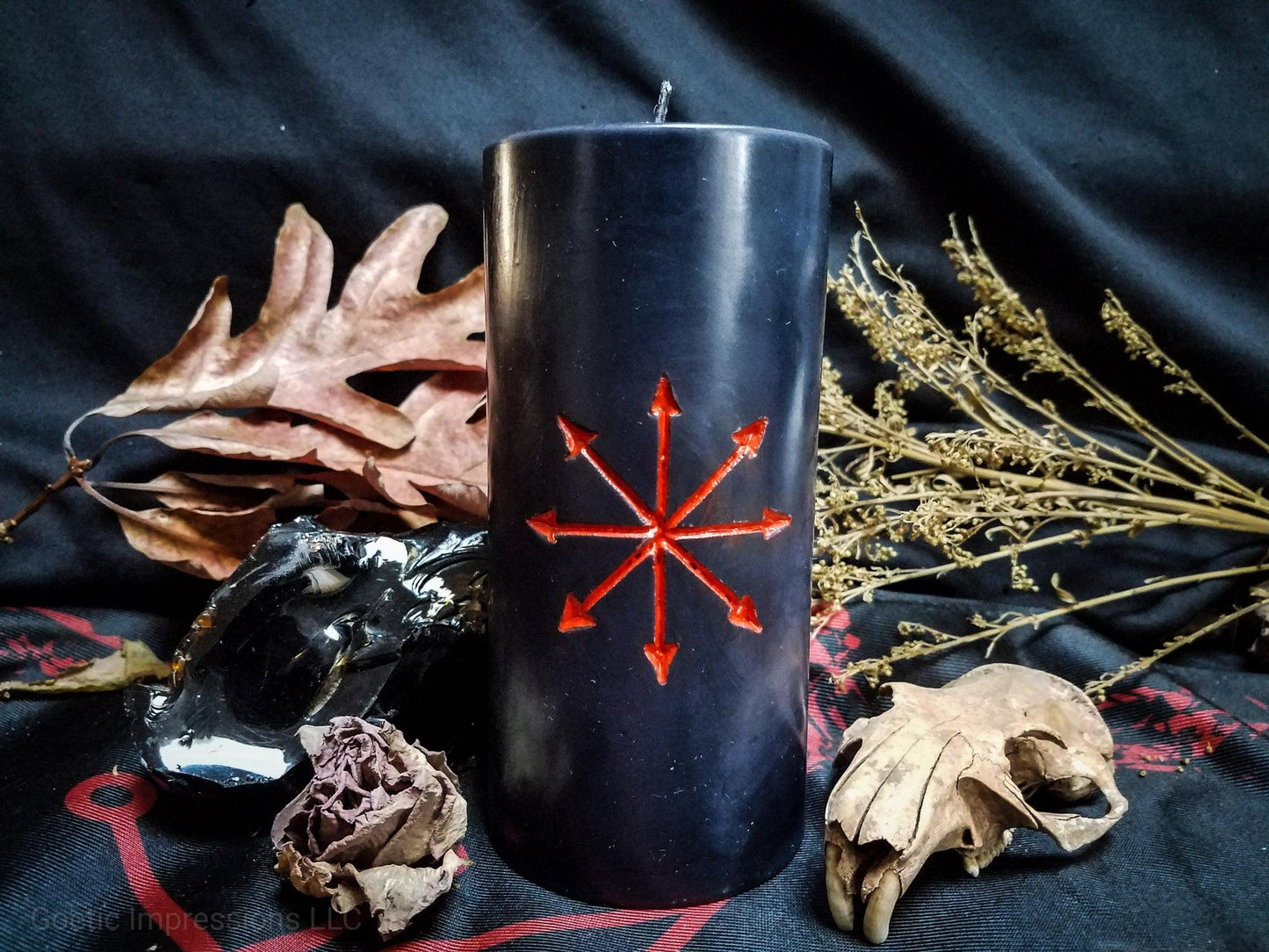 Black candle with red Chaos Star sigil carved into it.