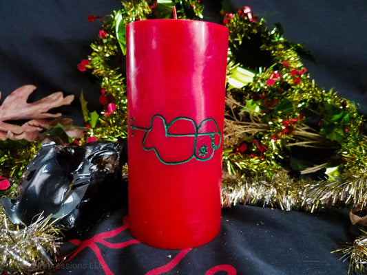 Red pillar candle with green Clauneck sigil carved into it