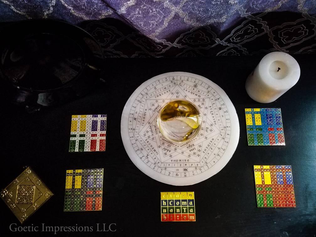 Ritual setup with Enochian watchtower tablets, tablet of union, crystal ball, wax sigillum and golden lamen.