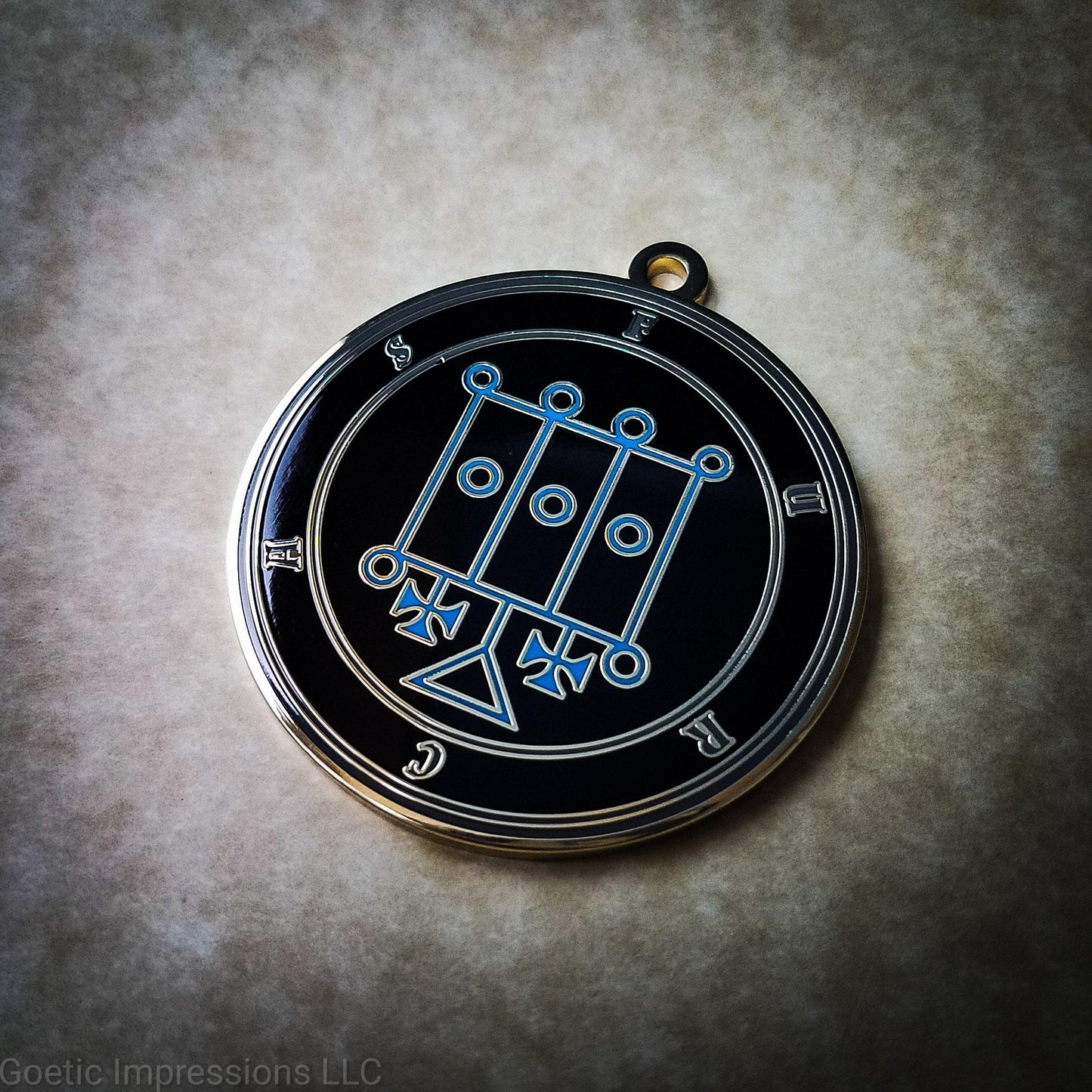 Talisman of goetic spirit Furcas. Furcas's sigil is blue with the circles surrounding in gray along with the name on a black background. 