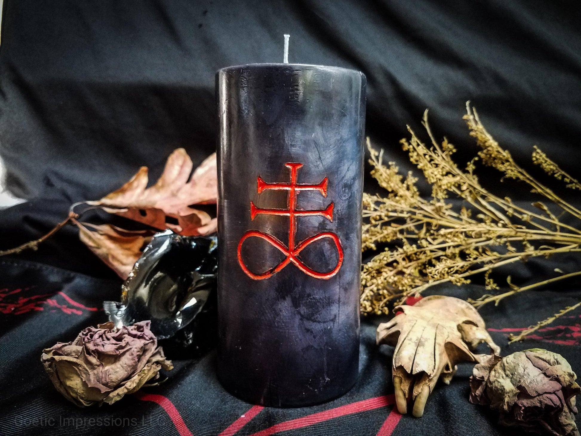 Black candle with red Leviathan sigil carved into it.