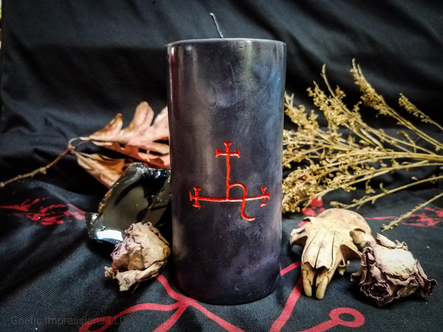 Black pillar candle with red Lilith sigil carved into it