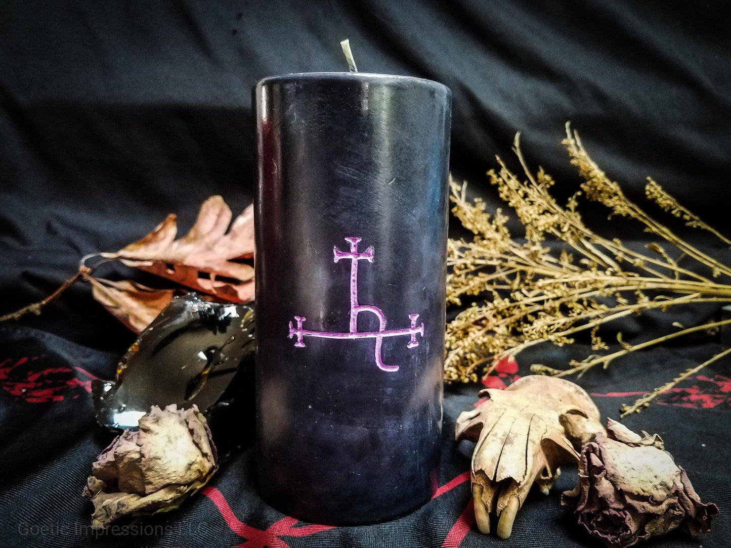 Black pillar candle with purple Lilith Sigil carved into it.
