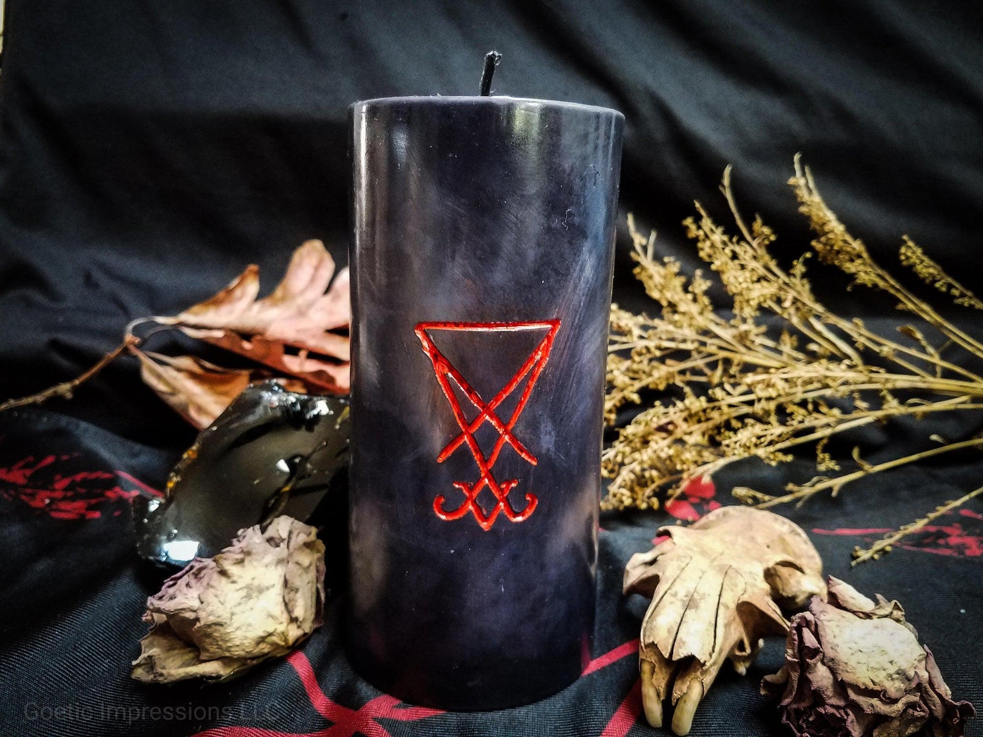 Black pillar candle with Sigil of Lucifer carved into it in red