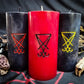 Pillar candles with Lucifer sigils carved into them.