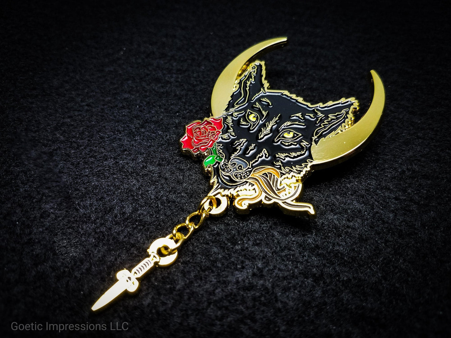 Lupercalia pin featuring a black wolf with a crescent moon in the background. The wolf is holding a rose, leather strips and has a chain with a dagger attached to it. It is plated in gold.