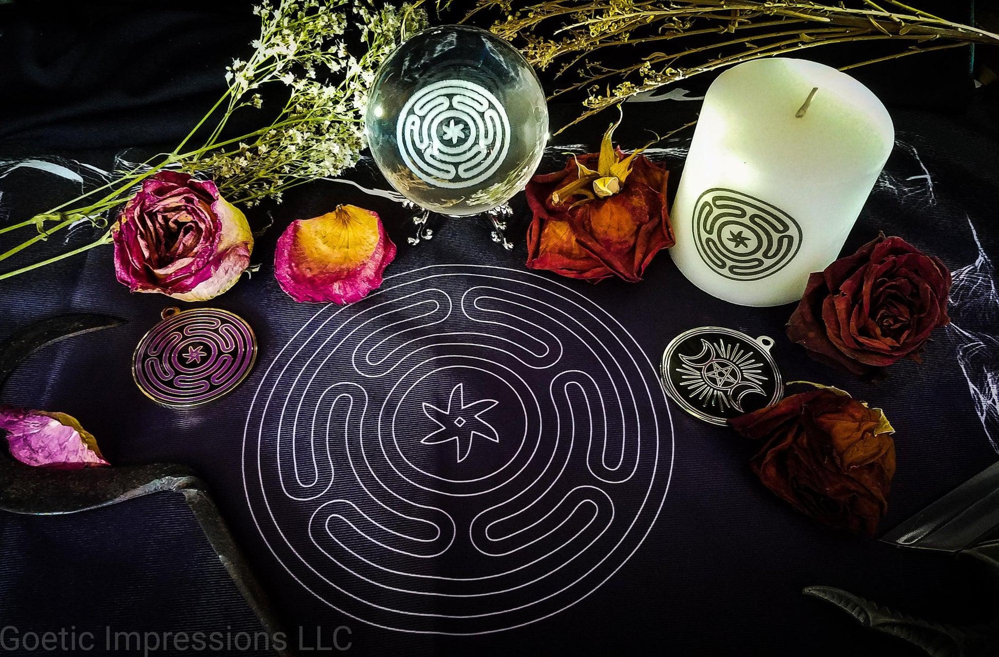 Hekate altar featuring crystal ball, talismans, candles and altar cloth