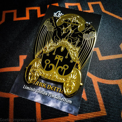 Black and gold hard enamel pin featuring the demon Belial. Belial is shown as two angels facing each other with arms interlocked.  They are standing in a flaming chariot.  The pin is on a black and orange Belial sigil altar cloth. The Belual pin is on a Goetic Impressions card back.