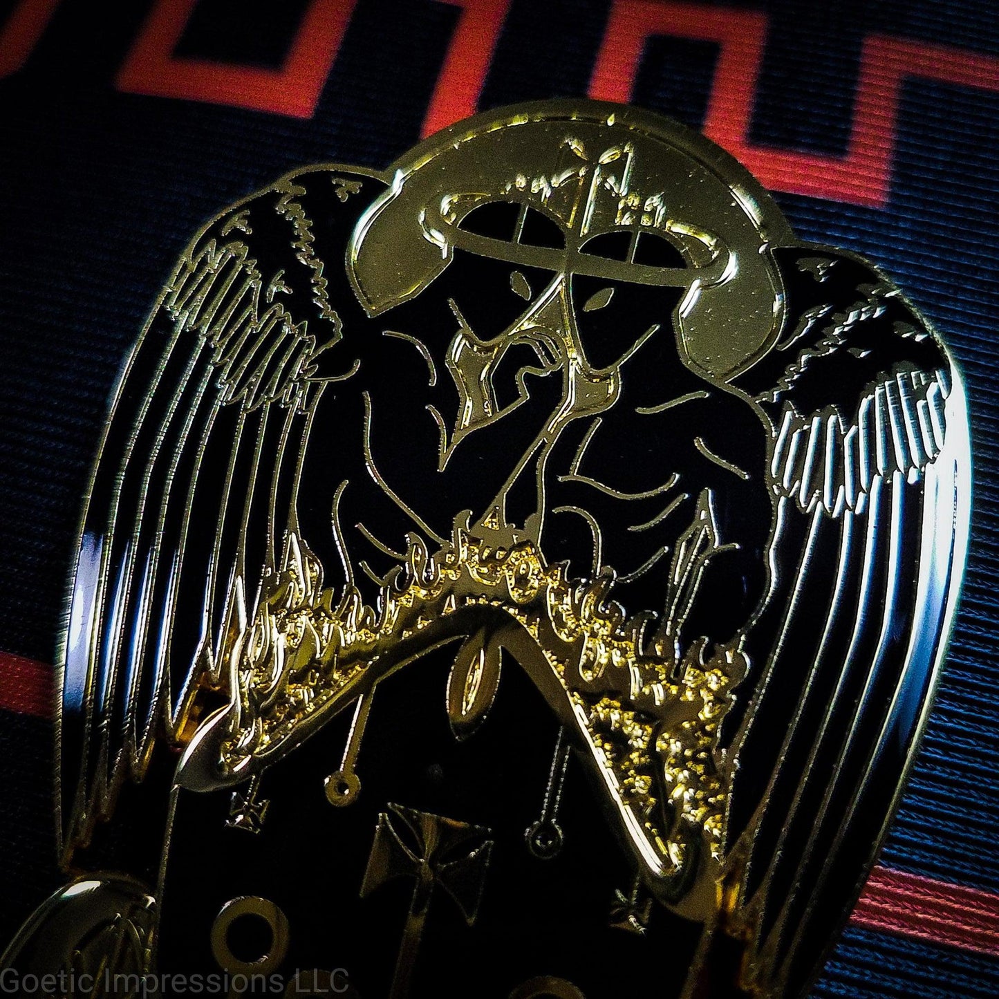 Close up of a black and gold Belial pin.
