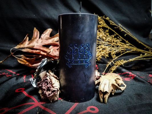 Black pillar candle with blue Paimon sigil carved into it.