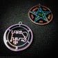 Two silver plated medallions featuring the front and back of the Ars Goetia spirit Phenex. The sigil is pink with the name and circle surrounding in purple. The Reverse is the TETRAGRAMMATON. The pentacle is blue with a red circle. Tetragrammaton is in red. The center sigil is green. 