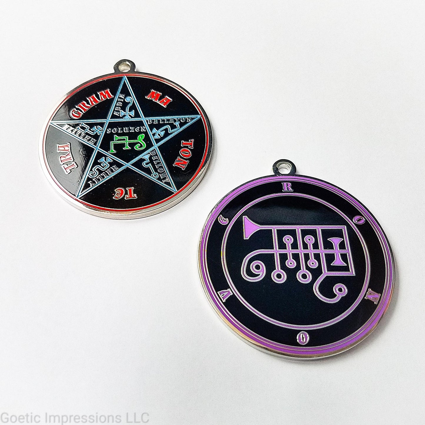 Two silver plated medallions featuring the front and back of the Ars Goetia spirit Ronove. The sigil is purple with the name and circle surrounding in purple. The Reverse is the TETRAGRAMMATON. The pentacle is blue with a red circle. Tetragrammaton is in red. The center sigil is green. 