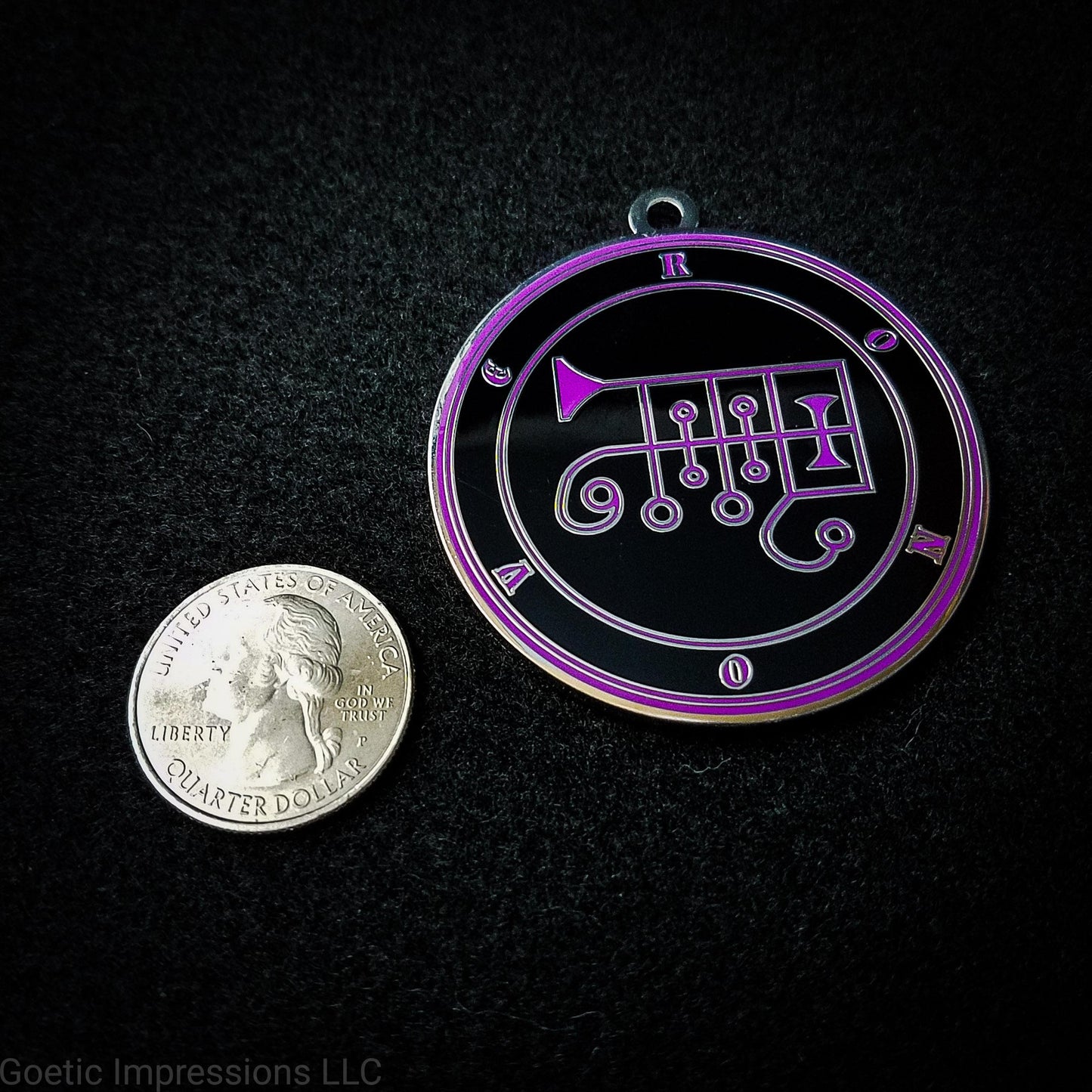 Seal of Ronove next to a quarter. The seal medallion measures two inches in diameter. The sigil is purple with purple letters and circles on a black background. 