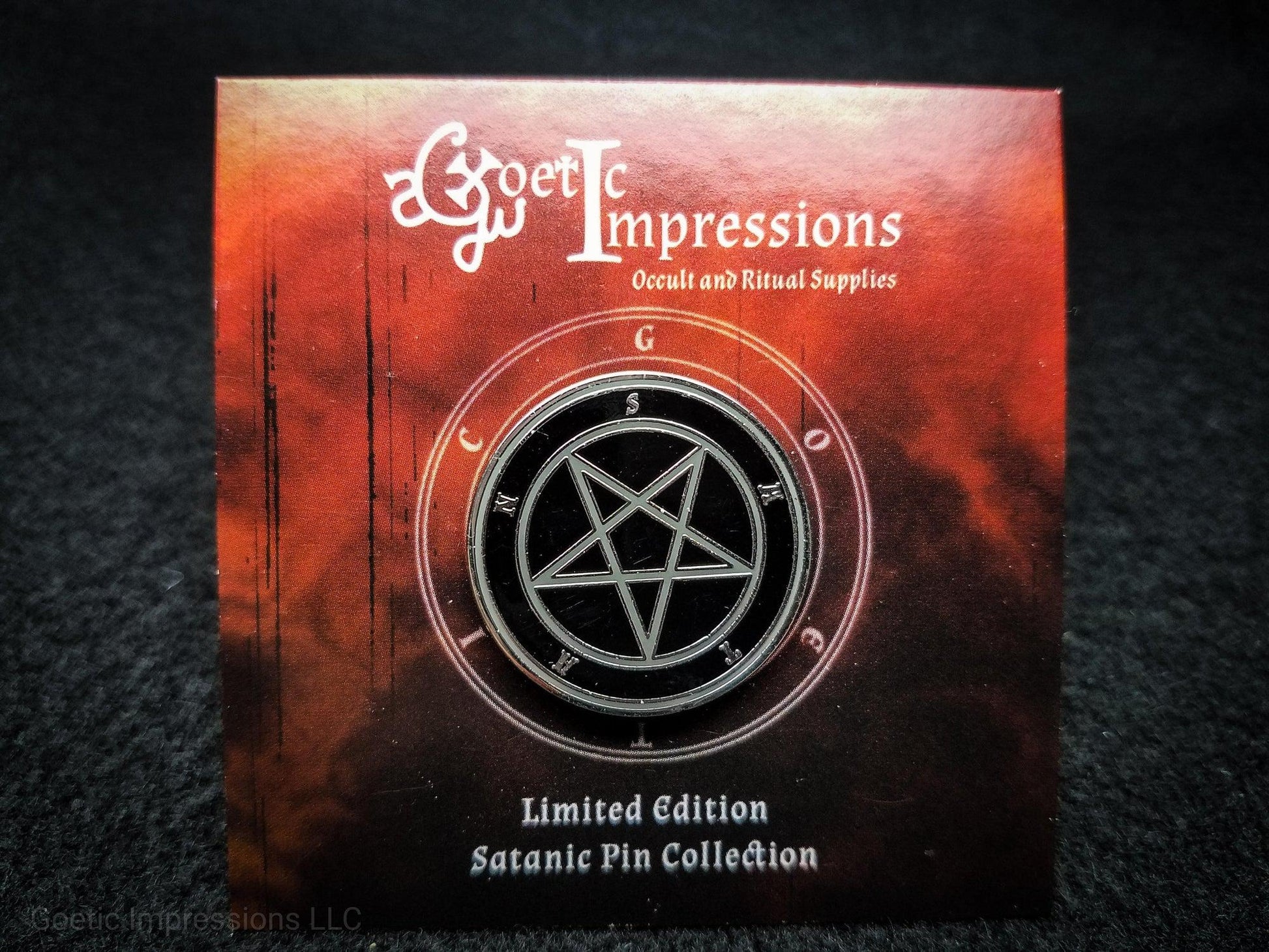 Satanic pin featuring a black, silver and grey Satan pin