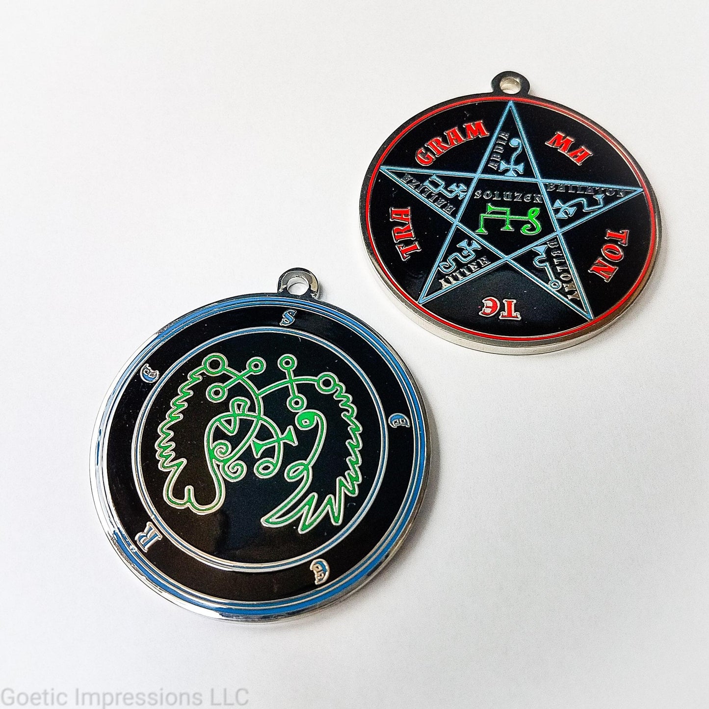 Two medallions featuring the front and back of the Ars Goetia spirit Seere. The sigil is green with the name and circle surrounding in blue.  The Reverse is the TETRAGRAMMATON.  The pentacle is blue with a red circle.  Tetragrammaton is in red. The center sigil is green. The seal is plated in silver.