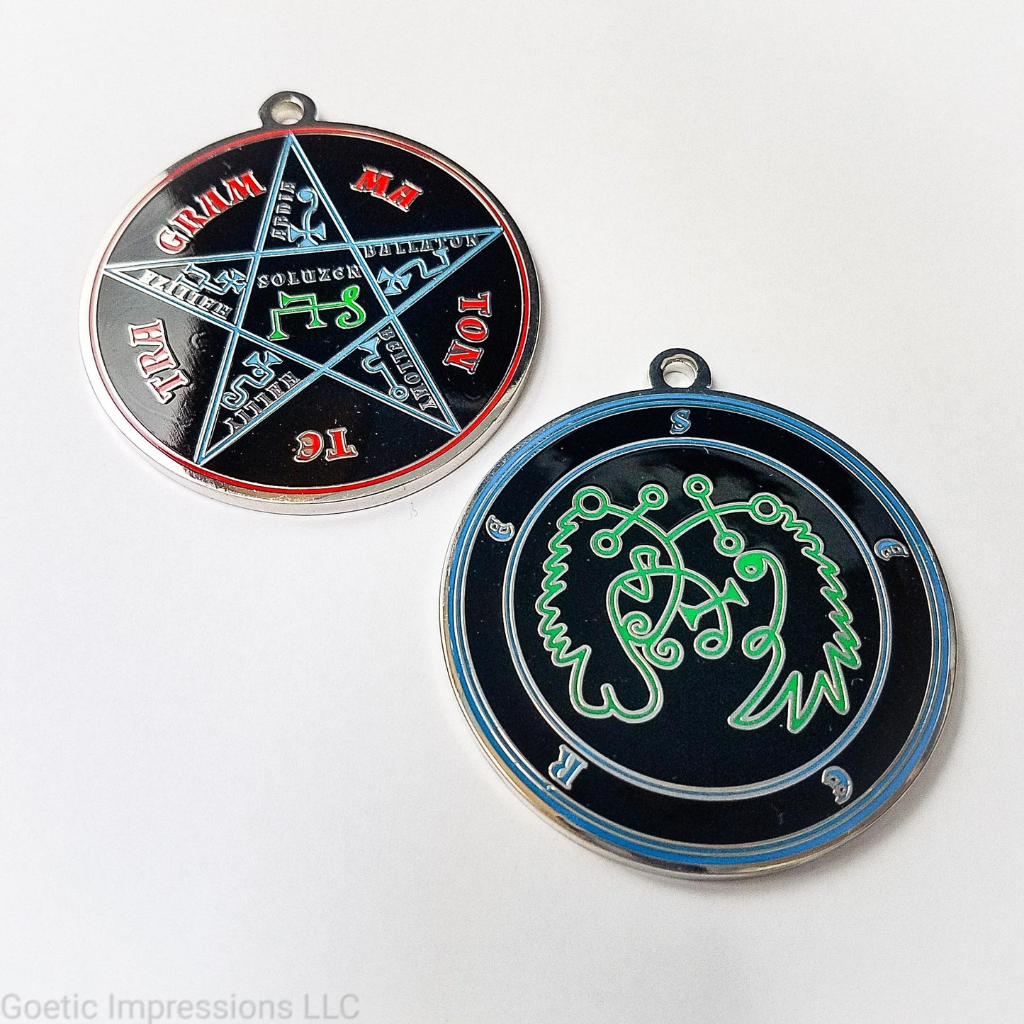 Two medallions featuring the front and back of the Ars Goetia spirit Seere. The sigil is green with the name and circle surrounding in blue.  The Reverse is the TETRAGRAMMATON.  The pentacle is blue with a red circle.  Tetragrammaton is in red. The center sigil is green. The seal is plated in silver.