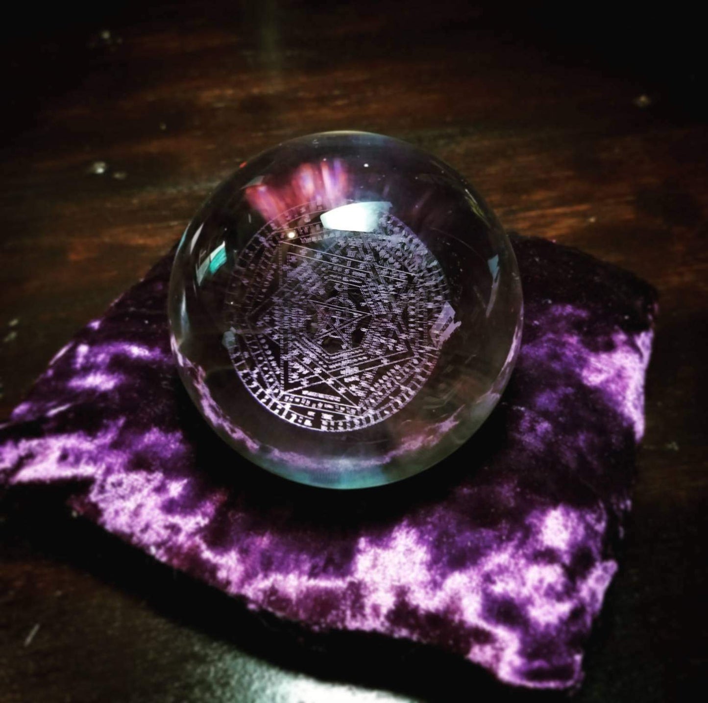 Crystal ball with the Sigillum Dei Aemeth engraved into it