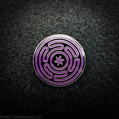 A silver plated hard enamel Hecate sigil pin. The sigil is purple on a black background with a silver plated outline.