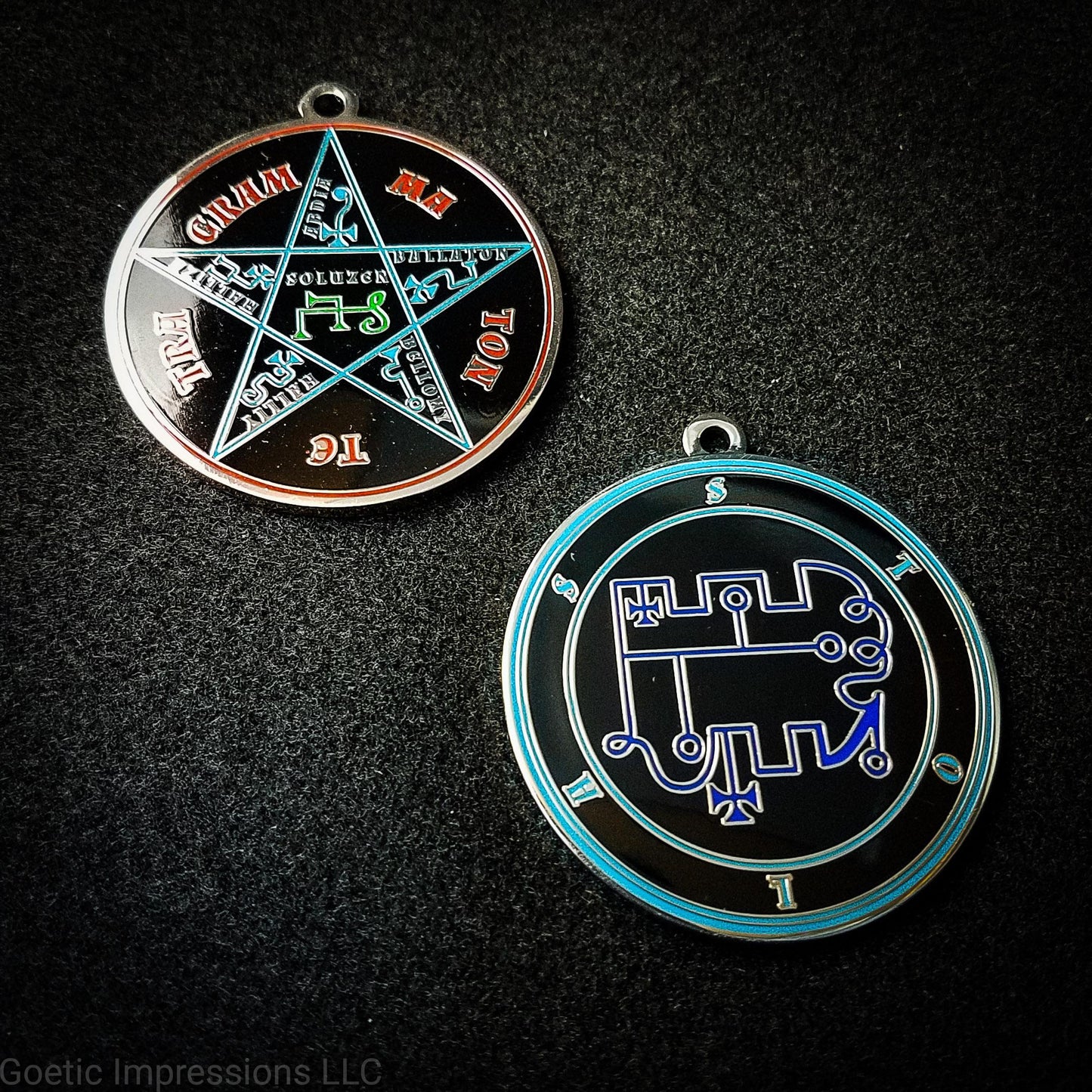 Two medallions featuring the front and back of the Ars Goetia spirit Stolas. The sigil is dark blue with the name and circle surrounding in teal. The Reverse is the TETRAGRAMMATON. The pentacle is blue with a red circle. Tetragrammaton is in red. The center sigil is green. The seal is plated in silver.