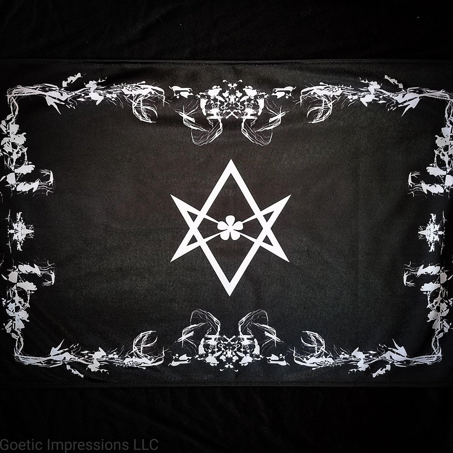 A black and white altar cloth with the Aleister Crowley Unicursal Hexagram from Thelema.