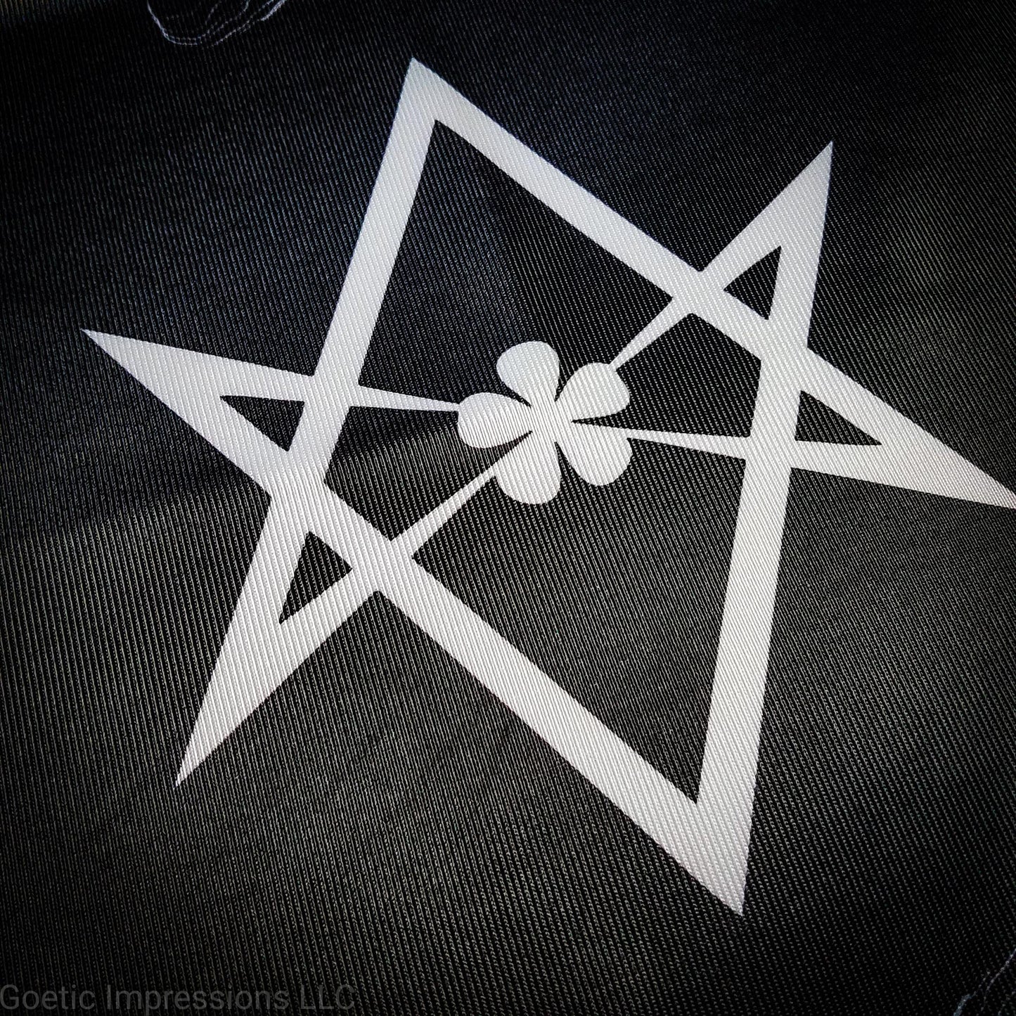 A black and white altar cloth with the Aleister Crowley Unicursal Hexagram from Thelema.