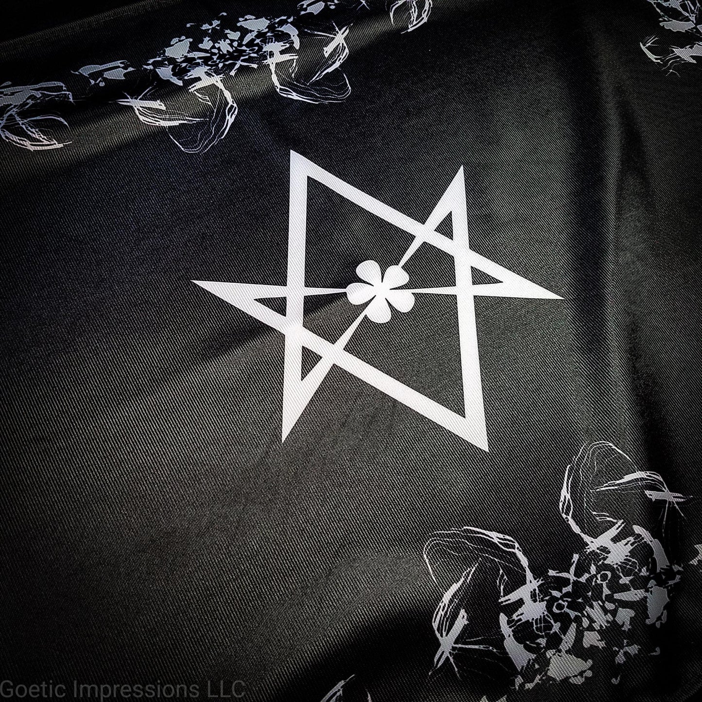 A black and white altar cloth with the Aleister Crowley Unicursal Hexagram from Thelema.